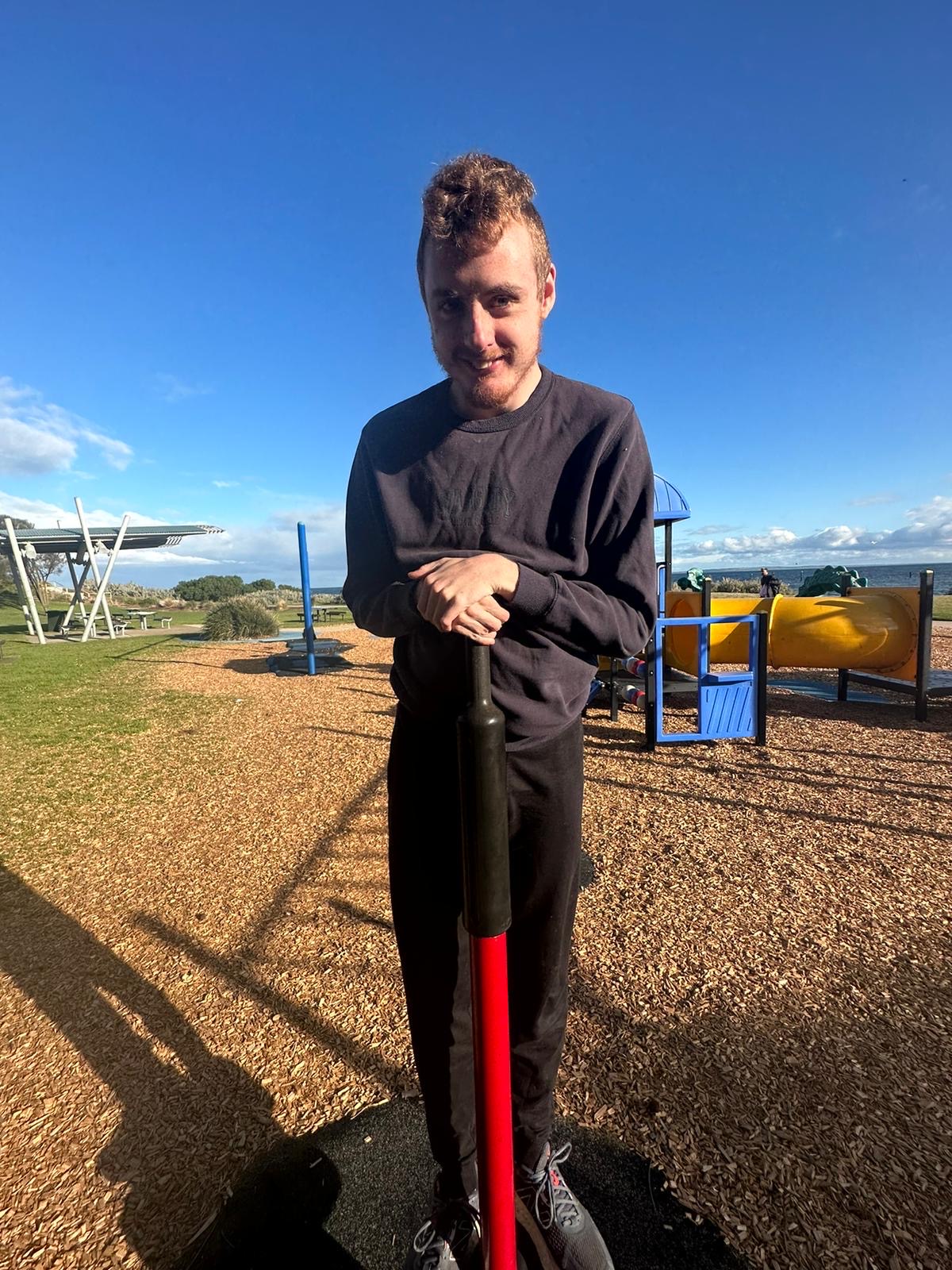 Participant smiling at the playground by the bay