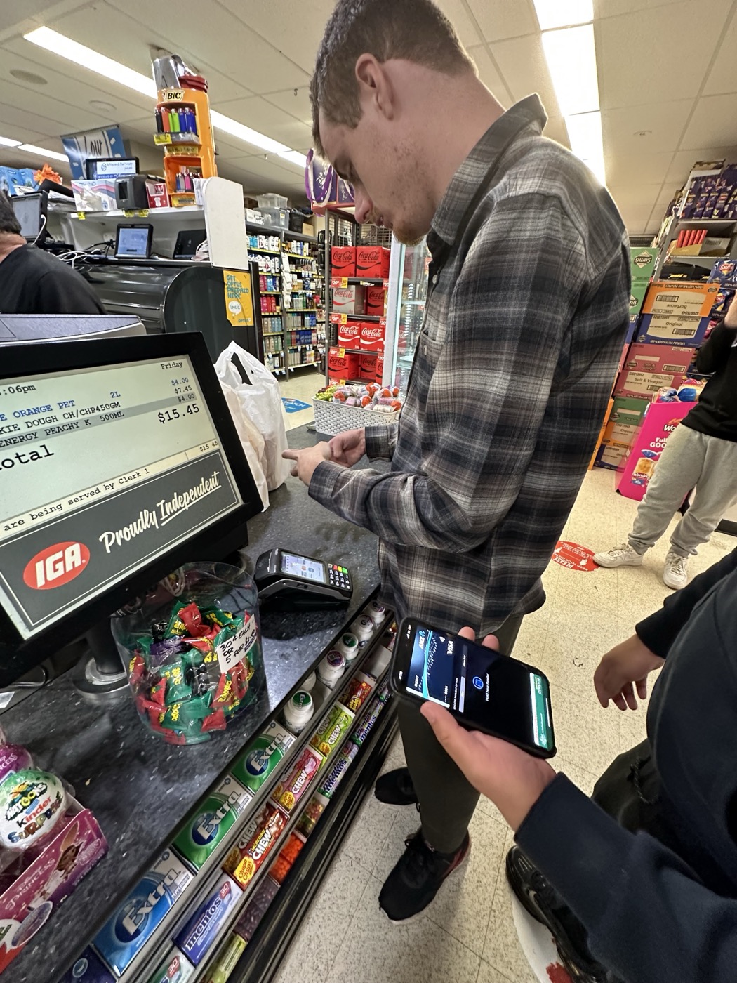 Support worker helping a participant at the IGA checkout, real in-home and everyday support